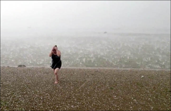Novosibirsk hail storm woman coming out the water