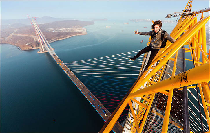 Vitaliy Raskalov stands atop Golden Horn bridge in Vladivostok