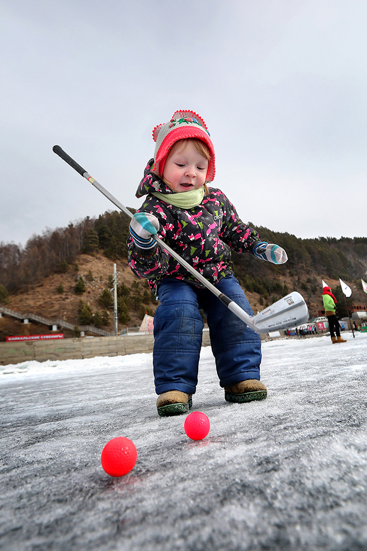 Teeing off for golf contest on frozen surface world’s deepest lake