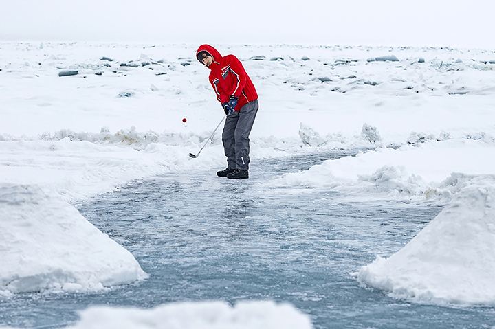 Teeing off for golf contest on frozen surface world’s deepest lake