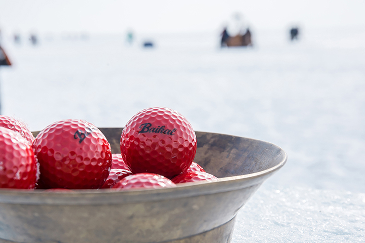 Teeing off for golf contest on frozen surface world’s deepest lake