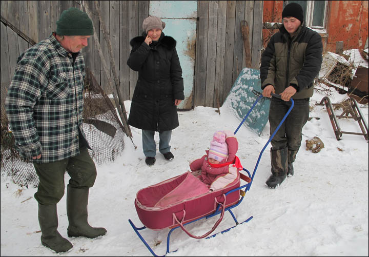 British baby enjoys her first sleigh rides in remote Siberian village where she is being raised 