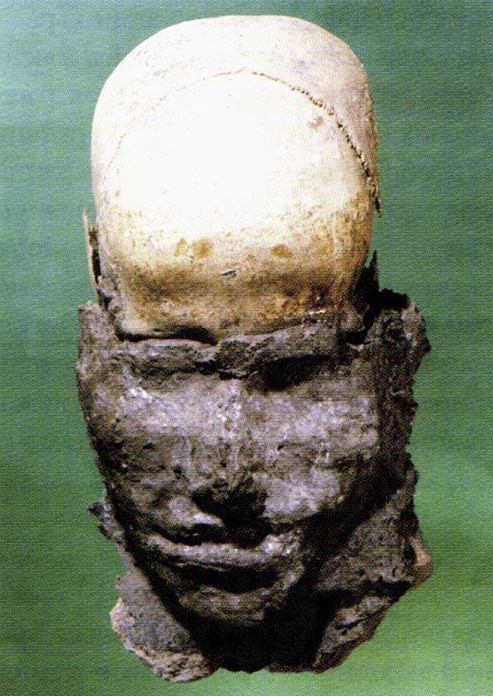 Head with clay modeled face