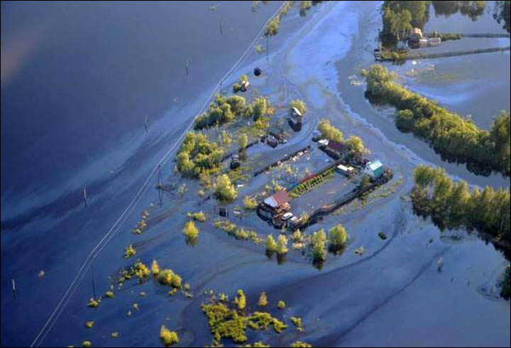 Floodwater from Ob River is black from spill as emergency workers flight to limit damage.