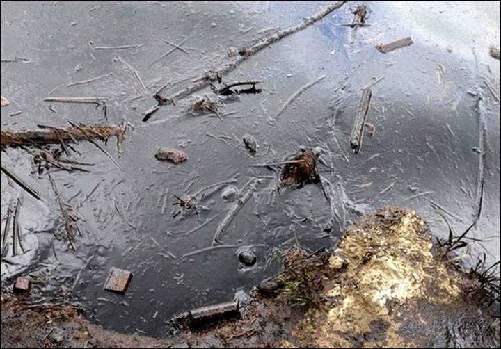 Floodwater from Ob River is black from spill as emergency workers flight to limit damage.