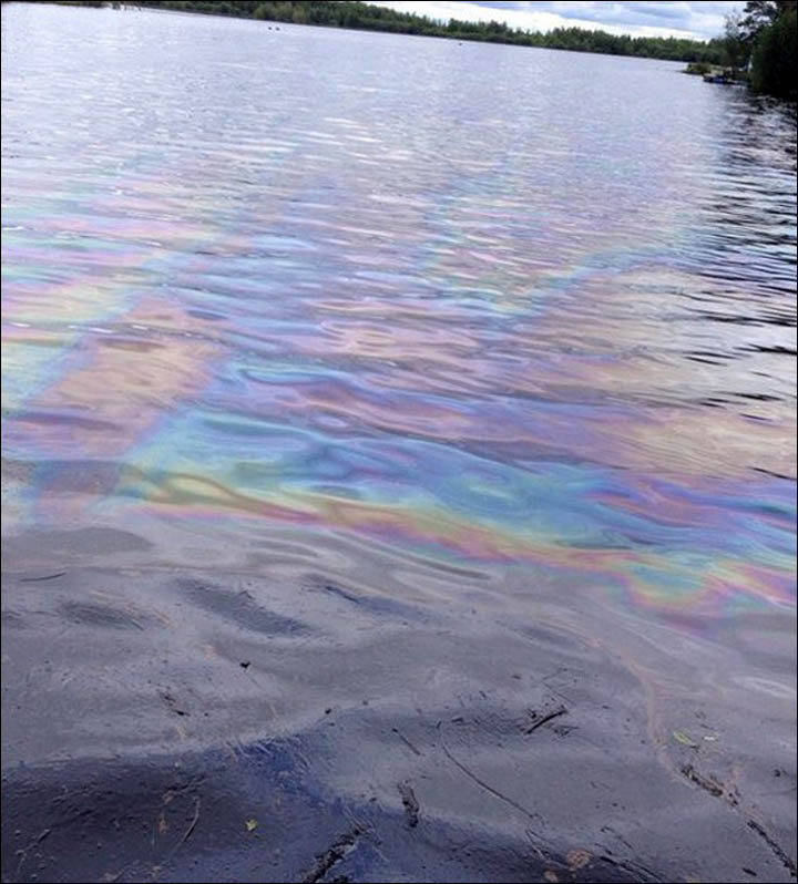 Floodwater from Ob River is black from spill as emergency workers flight to limit damage.
