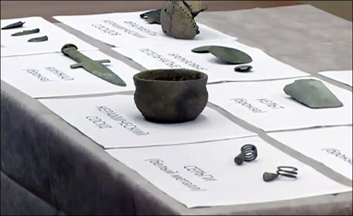 Ancient warrior unearthed marching to afterlife with his dagger drawn, wearing stylish earrings 