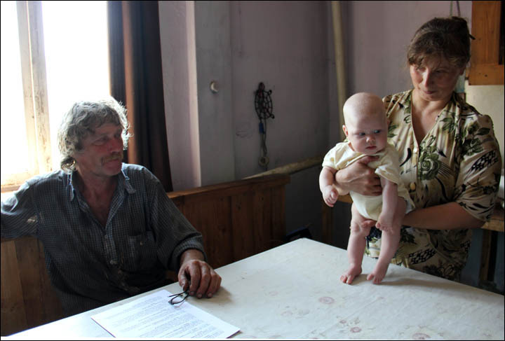 British baby enjoys her first sleigh rides in remote Siberian village where she is being raised 